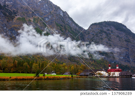 Autumn scenery of St. Bartholomew's Church in Konigssee, Germany, with its lakes and mountains. 137906289