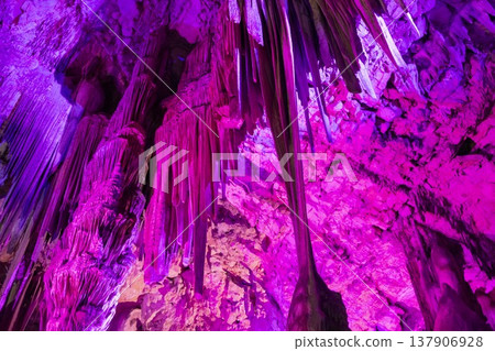 Exploring a colorful cave in Gibraltar with bright lights and unique rock formations Exploring a colorful cave in Gibraltar with bright lights and unique rock formations 137906928