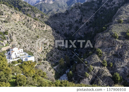 Stunning view of the Frigiliana valley with hills and houses under bright daylight in southern Spain Stunning view of the Frigiliana valley with hills and houses under bright daylight in southern Spain 137906938