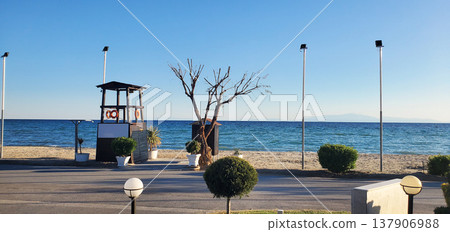 A seaside beach with a clean strip of sand and calm blue water A seaside beach with a clean strip of sand and calm blue water 137906988