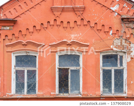 Three windows of the old mansion 19 century with brown bricks wall 137908029