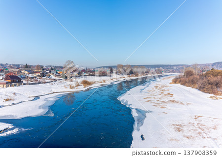 The spring river in the village began to thaw from the ice.The ice in the river began to melt. The spring river in the village began to thaw from the ice.The ice in the river began to melt. 137908359