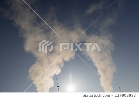 white steam coming from a pipe during heating of a large industrial premises in cold weather white steam coming from a pipe during heating of a large industrial premises in cold weather 137908958