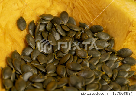 orange pumpkin seeds without husks, sliced pumpkin with baking pulp and healthy and nutritious seeds orange pumpkin seeds without husks, sliced pumpkin with baking pulp and healthy and nutritious seeds 137908984