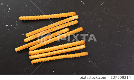 Grissini, also known as breadsticks on black marble like table, view from above Grissini, also known as breadsticks on black marble like table, view from above 137909214