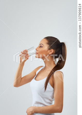 Beautiful woman holding water glass. Drink water. Girl with glass of water. Diet concept Beautiful woman holding water glass. Drink water. Girl with glass of water. Diet concept 137909814