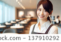 A warm and inviting cafe scene | Young female staff wearing aprons 137910292