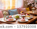 A spring cafe with lots of desserts on the table 137910308
