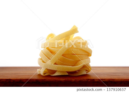 白色背景上放著乾的意大利寬麵條。 137910637