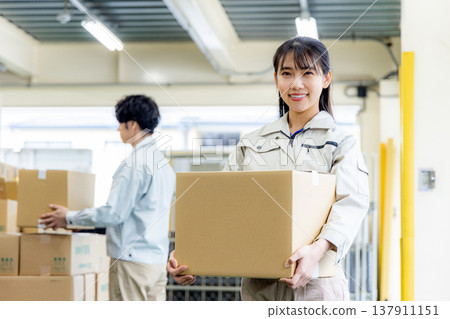 Young worker working in a warehouse Young worker working in a warehouse 137911151