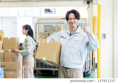 Young worker working in a warehouse Young worker working in a warehouse 137911157