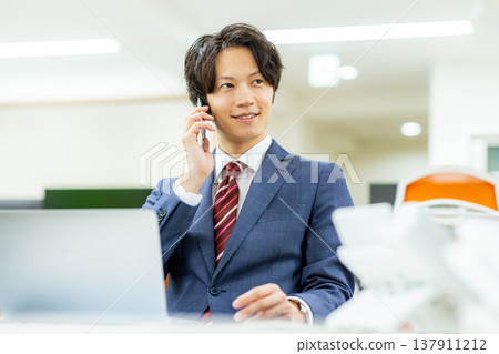 A man talking on a smartphone A man talking on a smartphone 137911212
