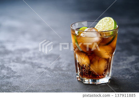 Cuba Libre alcoholic cocktail on dark background, selective focus. 137911885