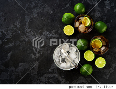 Glasses of tasty Cuba Libre cocktail on dark wooden background, top view. 137911906
