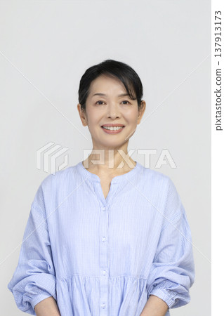 A woman in her 50s smiling at the camera 137913173