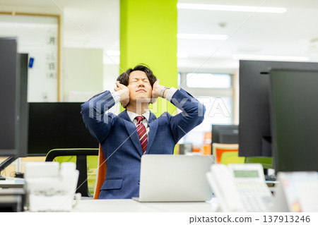 A tired businessman in the office A tired businessman in the office 137913246