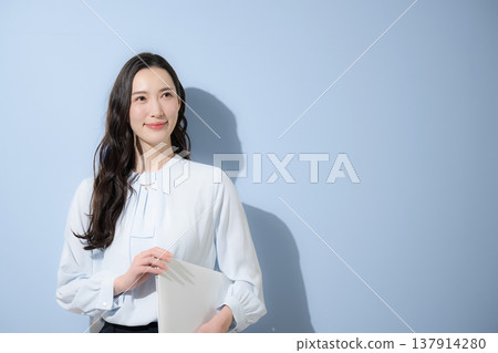 Business advertising image expressing recruitment and aspirations for talent and careers, with the subject looking directly at the camera against a light blue background. Business advertising image expressing recruitment and aspirations for talent and careers, with the subject looking directly at the camera against a light blue background. 137914280