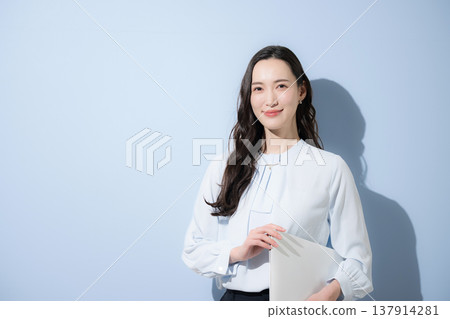 Business advertising image expressing recruitment and aspirations for talent and careers, with the subject looking directly at the camera against a light blue background. Business advertising image expressing recruitment and aspirations for talent and careers, with the subject looking directly at the camera against a light blue background. 137914281