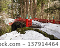 red bridge covered with snow 137914464