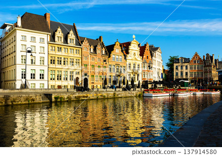 Medieval buildings in historical center of Ghent reflecting in water of river Leie Flanders Medieval buildings in historical center of Ghent reflecting in water of river Leie Flanders 137914580