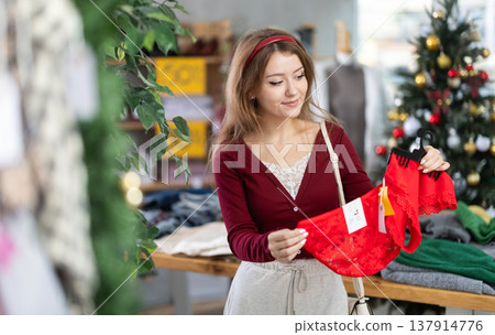 Woman choosing red panties before the new year Woman choosing red panties before the new year 137914776