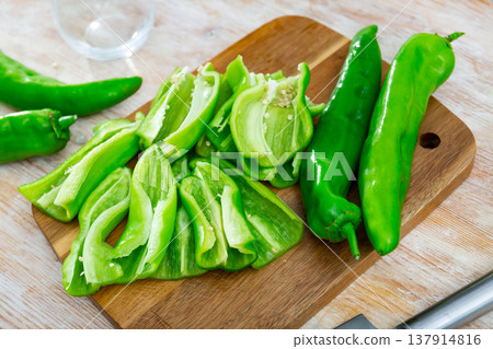 Sliced green peppers on board, food preparation 137914816