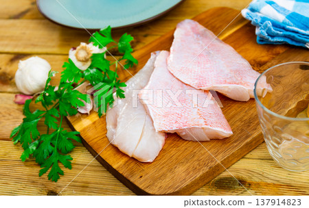 Raw chicken fillet on kitchen table Raw chicken fillet on kitchen table 137914823