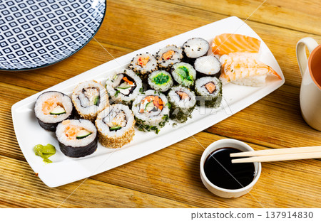 On table there portion set with maki - uramaki and nigiri On table there portion set with maki - uramaki and nigiri 137914830