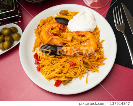 Traditional spanish seafood dish ith sauce in restaurant 137914847