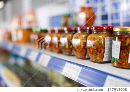 Jars of mustard stand on shelf in store Jars of mustard stand on shelf in store 137915008