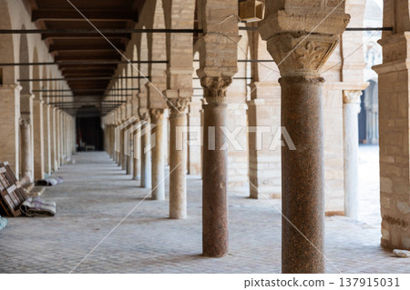 Long corridors under vaulted ceiling in ancient mosque of Kairouan in Tunisia. Long corridors under vaulted ceiling in ancient mosque of Kairouan in Tunisia. 137915031