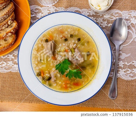 National Russian dish is Pickle soup with meat, cooked on basis of pickled cucumbers and pearl barley 137915036