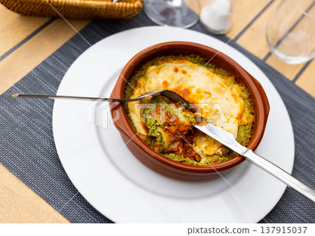 Lasagna with meat and spinach on platter 137915037