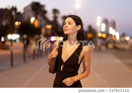 In evening, smiling girl walks around old city district Barceloneta, in vicinage of Citadel Park In evening, smiling girl walks around old city district Barceloneta, in vicinage of Citadel Park 137915110