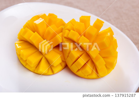 Deliciously served fresh mangoes diced and laid out on plate Deliciously served fresh mangoes diced and laid out on plate 137915287