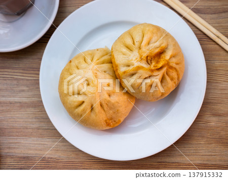Steamed Chinese baozi Xiaolongbao on white plate 137915332