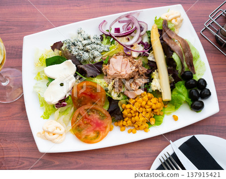Appetizing salad with tuna, cheese, corn and olives Appetizing salad with tuna, cheese, corn and olives 137915421