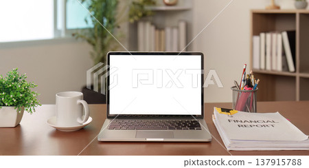 Professional desk setup with financial report and laptop Professional desk setup with financial report and laptop 137915788
