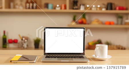 Kitchen workspace with laptop and coffee cup Kitchen workspace with laptop and coffee cup 137915789