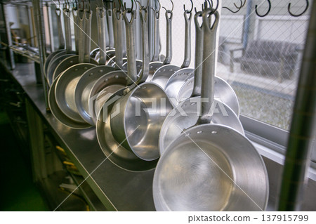 Commercial cooking pots lined up in the kitchen Commercial cooking pots lined up in the kitchen 137915799