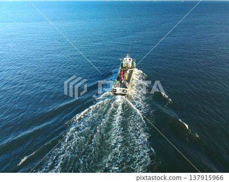 Aerial view of fishing boats entering and leaving Ochibe Fishing Port in Yakumo Town, Hokkaido, in early spring. Aerial view of fishing boats entering and leaving Ochibe Fishing Port in Yakumo Town, Hokkaido, in early spring. 137915966