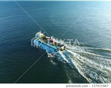 Aerial view of fishing boats entering and leaving Ochibe Fishing Port in Yakumo Town, Hokkaido, in early spring. Aerial view of fishing boats entering and leaving Ochibe Fishing Port in Yakumo Town, Hokkaido, in early spring. 137915967