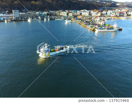 Aerial view of fishing boats entering and leaving Ochibe Fishing Port in Yakumo Town, Hokkaido, in early spring. Aerial view of fishing boats entering and leaving Ochibe Fishing Port in Yakumo Town, Hokkaido, in early spring. 137915968