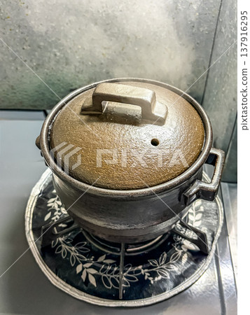 Rice cooked to perfection in an earthenware pot. Rice cooked to perfection in an earthenware pot. 137916295