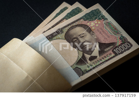 A stack of bills. A dark image. 137917159