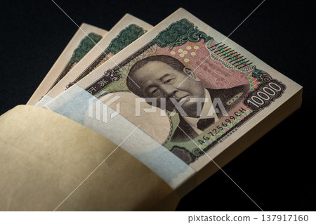 A stack of bills. A dark image. A stack of bills. A dark image. 137917160