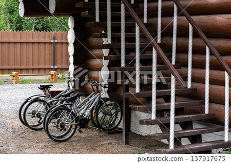 Bicycles near a wooden house. Bicycles near a wooden house. 137917675