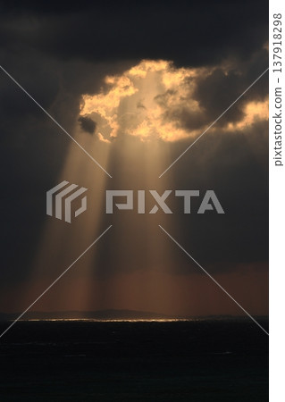 Weather, scenery, rays of light: sunlight pouring straight down onto the sea from between the clouds. A beautiful "Jacob's Ladder" in Ishigaki Island in March. Weather, scenery, rays of light: sunlight pouring straight down onto the sea from between the clouds. A beautiful "Jacob's Ladder" in Ishigaki Island in March. 137918298