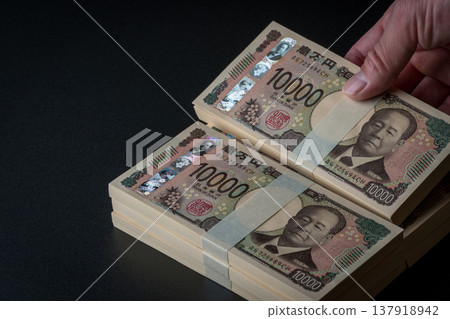 A stack of bills. A dark image. 137918942