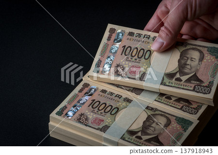 A stack of bills. A dark image. A stack of bills. A dark image. 137918943